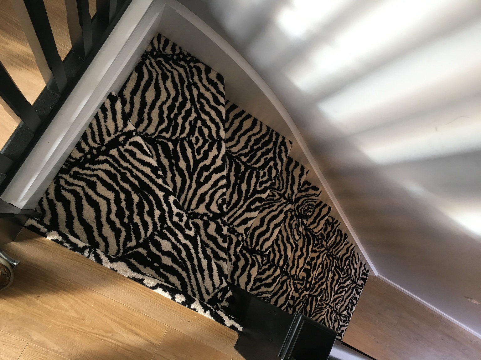 Detail of animal-print carpet on winding stairs