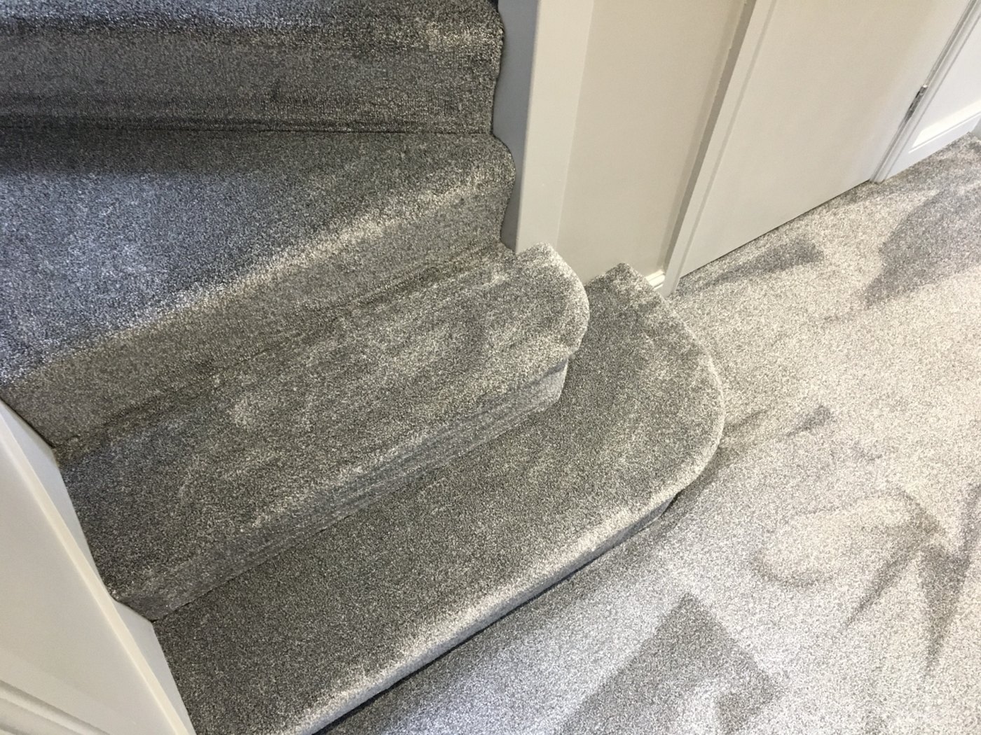 Grey carpet around curved steps