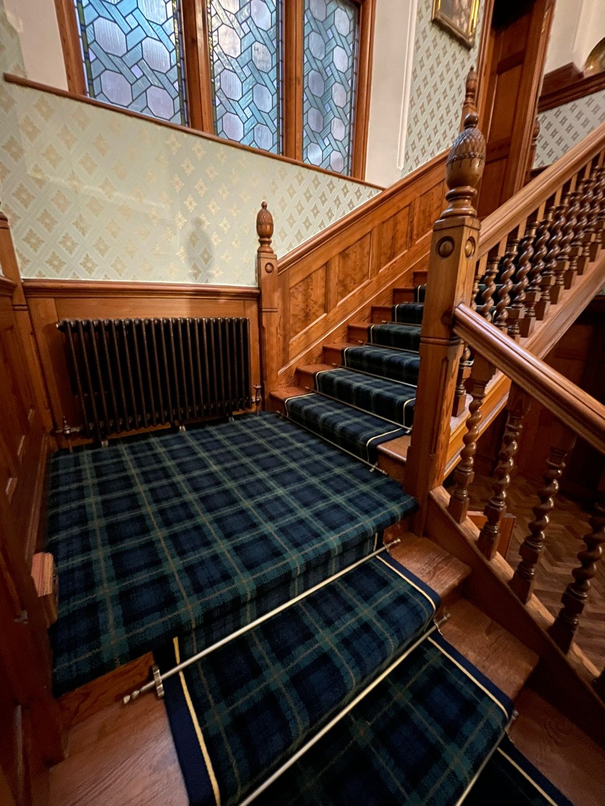 Tartan carpet and brass stair rods